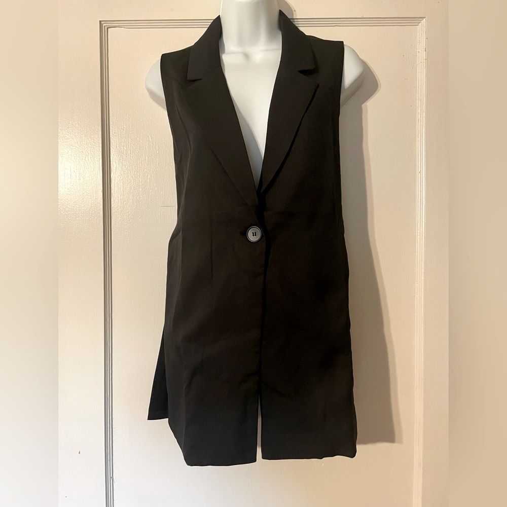Like new Small tux type black top. Open sides with button closure.